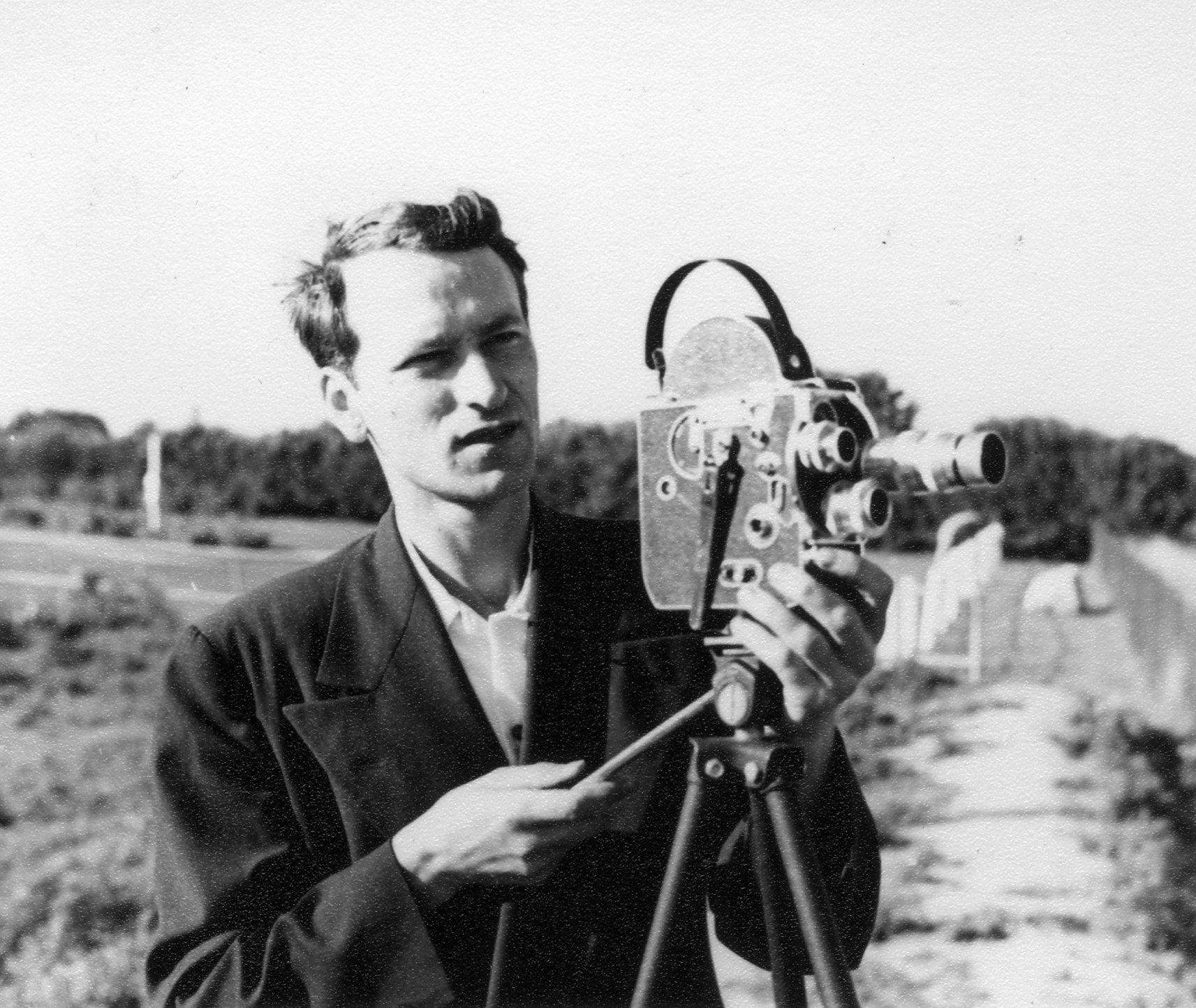 A photo of Jonas Mekas with a camera.