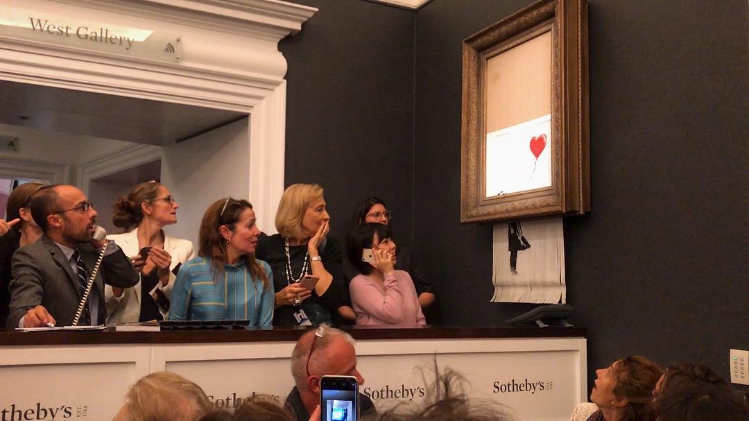 Banksy posted a photo on Instagram of the shredded work dangling from the bottom of the frame with the title “Going, going, gone … ”