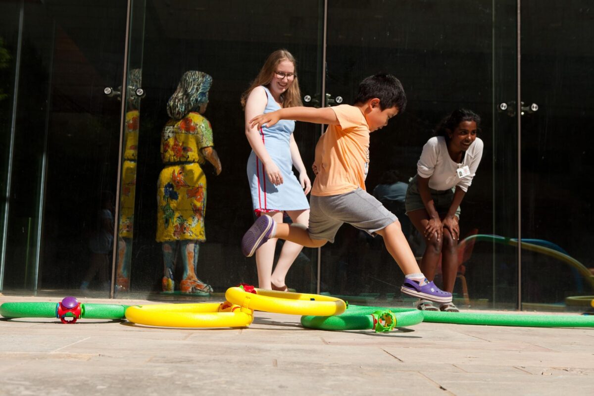 During the Summer program Summer Spin, children play in front of the Chazen Art Museum.