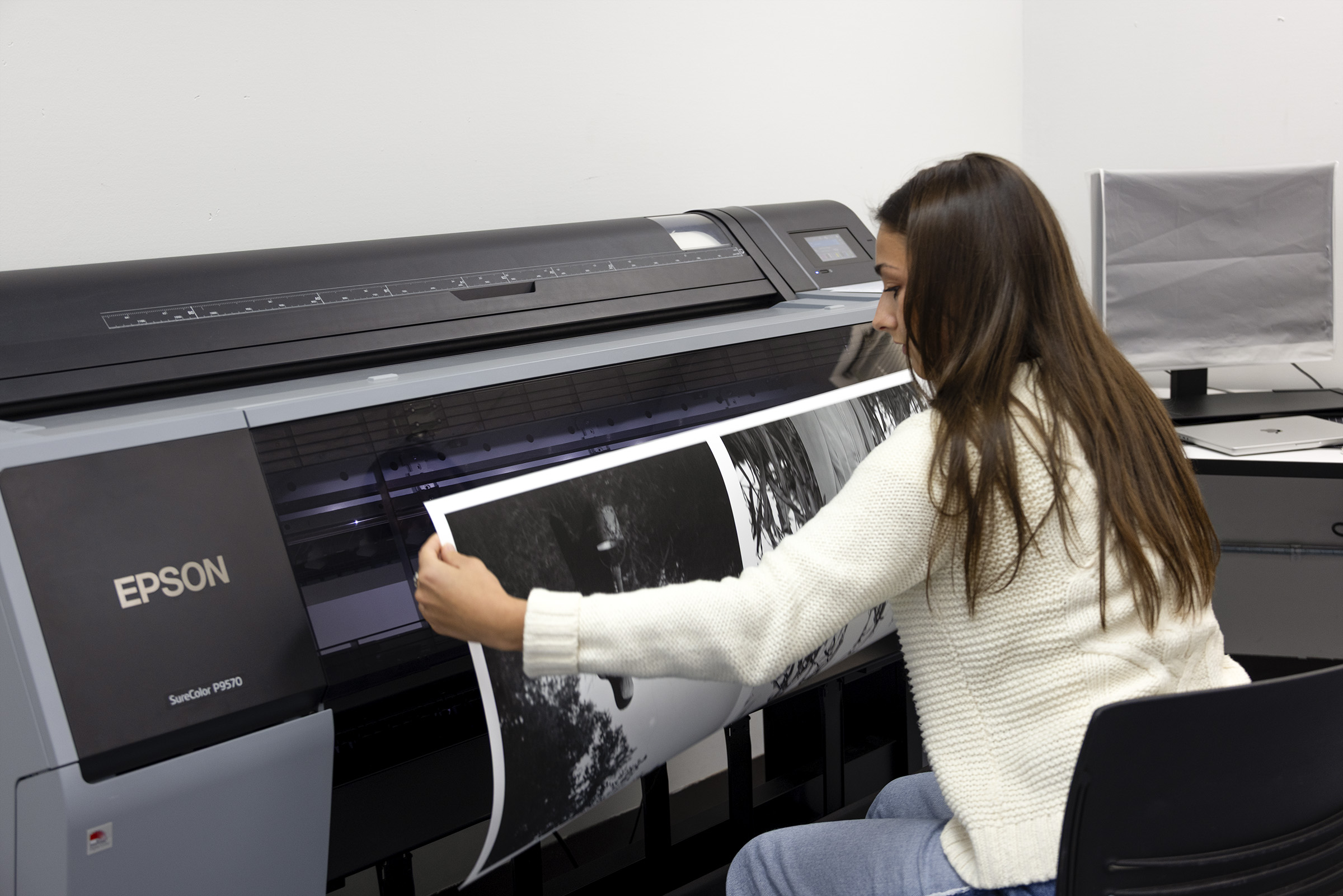 A student pulls a digital photography print from the printer in the Photography class at the University of Wisconsin-Madison.